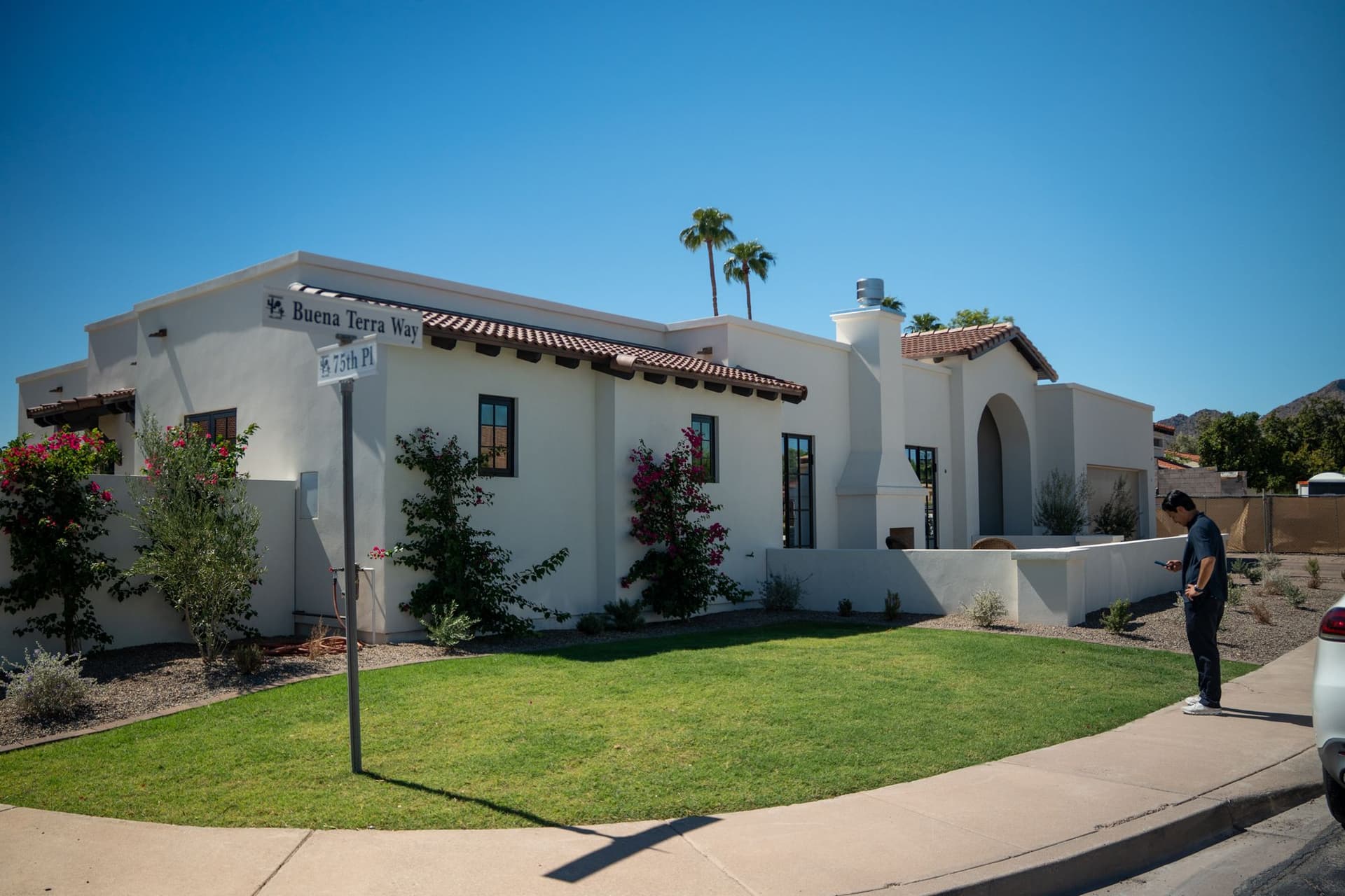 Finished white stucco residence with tile roofing and black-framed windows